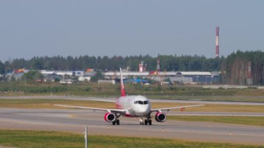 MOSCOW, RUSSIAN FEDERATION - JULY 31, 2021: Sukhoi Superjet 100 of Rossiya taxiing after landing at Sheremetyevo Airport SVO. Tourism and travel concept.