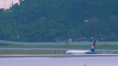 PHUKET, THAILAND - NOVEMBER 27, 2019: Boeing 757 of Azur Air brakes after landing at Phuket airport. Azur Air is a Russian charter airline. Tourism and travel concept