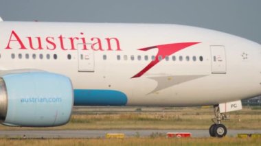 FRANKFURT AM MAIN, GERMANY - JULY 19, 2017: Boeing 777 of Austrian Airlines taxiing at Frankfurt Airport, Germany. Tourism and travel concept, air flight.