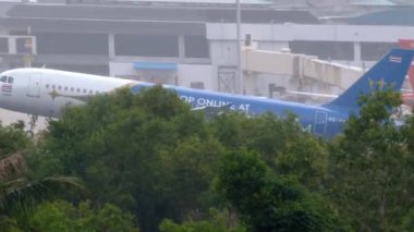 PHUKET, THAILAND - NOVEMBER 28, 2019: AirAsia Airbus A320 HS-ABX in KingPower livery landing on the Phuket airport. Mai Khao beach