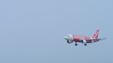 PHUKET, THAILAND - NOVEMBER 28, 2019: Thai AirAsia Airbus 320 HS-ABH approaching and landing, International Phuket Airport