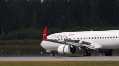 MOSCOW, RUSSIAN FEDERATION - JULY 29, 2021: Side view of Boeing 737 of Nordwind braking after landing at Sheremetyevo Airport SVO. Travel and tourism concept. Airplane on runway, airport traffic