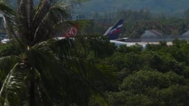 PHUKET, THAILAND - NOVEMBER 27, 2019: Passenger huge airliner arriving at Phuket airport, medium shot side view footage. Boeing 747 Thai Airways landing at Airport. Passenger jumbo jet flies. Tourism
