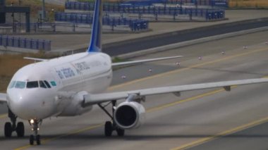 FRANKFURT AM MAIN, GERMANY - JULY 19, 2017: Front view Airbus A320 Air Astana taxiing on the airfield at Frankfurt Airport, Germany. Tourism and travel concept, air flight