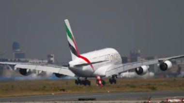 FRANKFURT AM MAIN, GERMANY - JULY 18, 2017: Commercial airplane Airbus A380 of Emirates landing at Frankfurt airport, Germany. Huge double-deck airliner opened landing gear and ready to land, medium