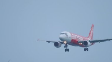 PHUKET, THAILAND - NOVEMBER 28, 2019: Airbus 320 AirAsia approaching and landing at Phuket Airport. Passenger Asian low-cost airline flies