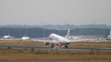 FRANKFURT AM MAIN, GERMANY - JULY 20, 2017: Slow motion shot of passenger plane of Adria Airways landing at Fraport, Frankfurt, Germany. Adria Airways Slovenian airline. Aviation, tourism and travel