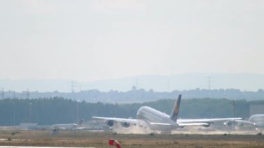 FRANKFURT AM MAIN, GERMANY - JULY 20, 2017: Wide body Airbus A380 of Lufthansa departure at Fraport, Frankfurt, Germany. Huge double-deck airliner flies away, long shot. Aviation, tourism and travel