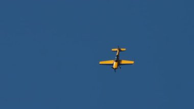 A light-engine plane flies vertically down at an air show. Extreme demonstrations, sports plane flights