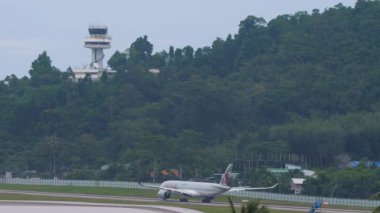 PHUKET, THAILAND - NOVEMBER 28, 2019: Long shot, Qatar Airways passenger plane on the runway of Phuket airport. Travel and tourism concept