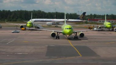 MOSCOW, RUSSIAN FEDERATION - JULY 24, 2021: Passenger aircraft S7 Airlines taxiing to the terminal of Domodedovo airport. Aviation Traffic. Singapore Airlines plane at the airport