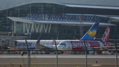PHUKET, THAILAND - NOVEMBER 26, 2015: Commercial airplane Airbus A320 of AirAsia taxiing to the runway at Phuket Airport HKT. Tourism and travel concept.