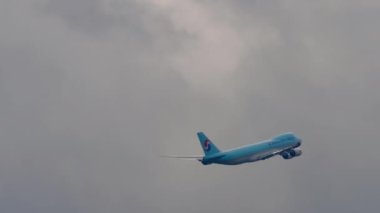 MOSCOW, RUSSIAN FEDERATION - JULY 29, 2021: Freight carrier Boeing 747 of Korean Air departure at Sheremetyevo International Airport SVO. Long shot, jumbo jet climbing into the clouds