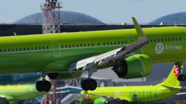 NOVOSIBIRSK, RUSSIAN FEDERATION - JUNY 12, 2022: Slow motion, civil plane of S7 Airlines landing at Tolmachevo airport. Cinematic footage aircraft slowly flies, touching the runway. Travel concept