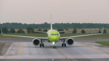NOVOSIBIRSK, RUSSIAN FEDERATION - JULY 24, 2021: Commercial plane S7 Airlines approaching the terminal at Tolmachevo airport. Airplane on the airfield. Tourism and travel concept, air flight.