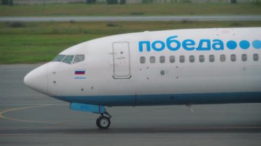 NOVOSIBIRSK, RUSSIAN FEDERATION - JULY 24, 2021: Side view of Boeing 737 Pobeda Airlines taxiing at Tolmachevo airport. Tourism and travel concept, air flight. Russian low cost airline
