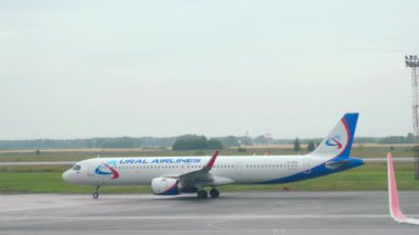 NOVOSIBIRSK, RUSSIAN FEDERATION - JULY 24, 2021: Passenger airbus Ural Airlines taxis to the terminal after landing at Tolmachevo airport. Tourism and travel concept, air flight.