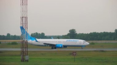NOVOSIBIRSK, RUSSIAN FEDERATION - JULY 24, 2021: Boeing 737 of Pobeda Airlines on the runway at Tolmachevo airport. Tourism and travel concept, air flight. Russian low cost airline