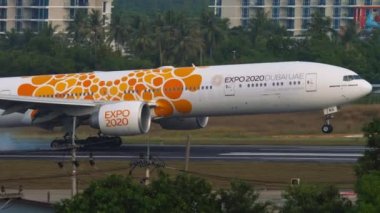 PHUKET, THAILAND - DECEMBER 3, 2018: Emirates Boeing 777 with Expo 2020 livery descending for landing at Phuket Airport HKT. Huge jet plane arrival