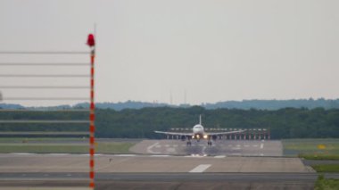 Commercial aircraft arrival, touchdown and braking. Front view, airliner landing