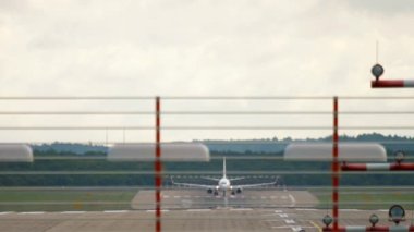 Footage of a passenger plane on the runway. Front view of an airliner set speed and take off. Tourism and travel concept. Aviation, departure traffic