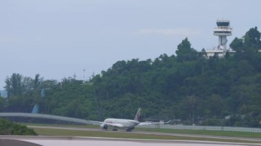 PHUKET, THAILAND - NOVEMBER 28, 2019: Civil airplane of Qatar Airways departure at Phuket airport. Tourism and travel concept, air flight