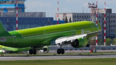 NOVOSIBIRSK, RUSSIAN FEDERATION - JUNY 12, 2022: Passenger airplane of S7 Airlines landing and braking at Tolmachevo airport. Cinematic footage aircraft slowly flies. Travel concept