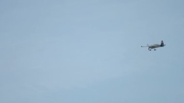 KAZAN, RUSSIAN FEDERATION, JUNE 14, 2019: Long shot of sports maneuverable aircraft performs acrobatic extreme stunts at the Red Bull air show in Kazan