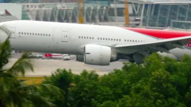PHUKET, THAILAND - DECEMBER 1, 2016: Footage of Boeing 777 Nordwind Airways landing, touching the runway and braking with smoke at Phuket airport HKT. Tourism and travel concept