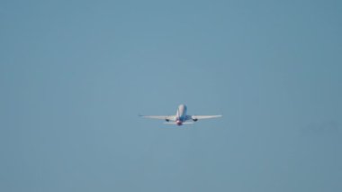 Long shot rear view of a jet plane taking off and climbing. Airliner flies away. Tourism and travel concept