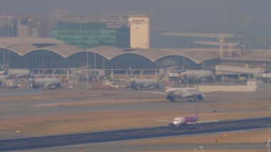 HONG KONG - NOVEMBER 10, 2019: Airbus A320 of Peach departure at Hong Kong airport. Peach low cost Japanese airline. Cinematic shot of an airplane take off, climb