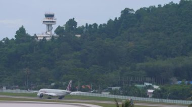 PHUKET, THAILAND - NOVEMBER 28, 2019: Civil airplane of Qatar Airways departure at Phuket airport. Tourism and travel concept, air flight