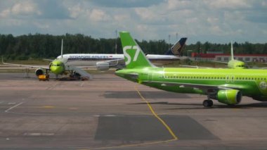 MOSCOW, RUSSIAN FEDERATION - JULY 24, 2021: Commercial plane of S7 Airlines taxiing to the terminal at Domodedovo airport. Aviation Traffic. Singapore Airlines plane at the airport
