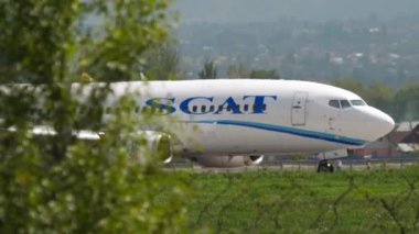 ALMATY, KAZAKHSTAN - MAY 4, 2019: Boeing 737, UP-B3718 of SCAT Airlines taxiing on the runway at Almaty airport, Kazakhstan. Civil aircraft braking after landing at the airport, side view