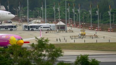 PHUKET, THAILAND - DECEMBER 1, 2016: Boeing 737 Nok Air taxiing on the runway at Phuket airport, Thailand HKT. Airport traffic, airfield and taxiways