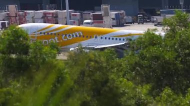 PHUKET, THAILAND - NOVEMBER 30, 2019: Side view footage plane arrived. Airbus A320-232, 9V-TRP of Scoot landing at Phuket airport. Tourism and travel concept