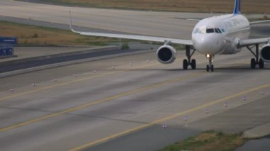 FRANKFURT AM MAIN, GERMANY - JULY 19, 2017: Airbus A320 Air Astana rides on the taxiway at Frankfurt Airport, Germany. Tourism and travel concept, air flight