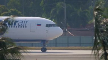 PHUKET, THAILAND - NOVEMBER 29, 2019: Airplane Boeing 767 of Azur Air taxiing at Phuket airport, side view. Tourism and aviation concept