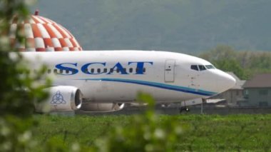 ALMATY, KAZAKHSTAN - MAY 4, 2019: Boeing 737 of SCAT Airlines taxiing on the runway at Almaty airport, Kazakhstan. Aircraft braking after landing at the airport, side view
