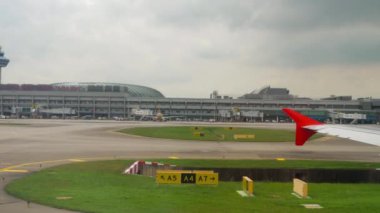 CHANGI, SINGAPORE - NOVEMBER 25, 2018: First-person view from an airplane window of Changi Airport, Singapore. Airplane takeoff. Tourism and aviation concept