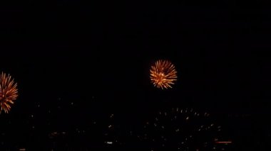 Bright festive fireworks in the night sky in the city. Holiday concept