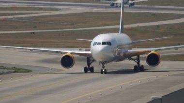 FRANKFURT AM MAIN, GERMANY - JULY 19, 2017: Boeing 767 of Condor taxiing after landing at Frankfurt airport. Footage of an airliner on the airfield. Tourism and aviation concept