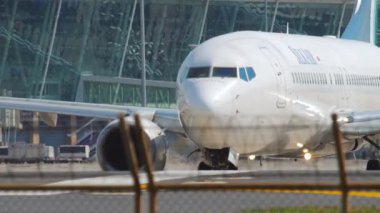 PHUKET, THAILAND - DECEMBER 02, 2018: Boeing 737 of SilkAir taxiing on the runway. Commercial airliner on the background of a modern airport terminal