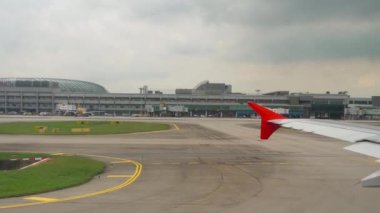 CHANGI, SINGAPORE - NOVEMBER 25, 2018: Airplane accelerating for takeoff. First person view of Changi Airport. Tourism and aviation concept