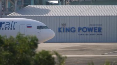 PHUKET, THAILAND - NOVEMBER 29, 2019: Commercial airplane Boeing 767 of Azur Air taxiing at Phuket airport, side view. Tourism and aviation concept