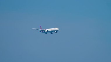 PHUKET, THAILAND - DECEMBER 02, 2018: Boeing 777 Thai Airways approach before landing at Phuket Airport. Wide body airliner flies. Tourism and travel concept