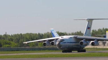 NOVOSIBIRSK, RUSSIAN FEDERATION - JUNY 12, 2022: Middle shot of transport aircraft IL 76 taxiing on runway at Tolmachevo airport. Il-76 Soviet heavy military transport aircraft