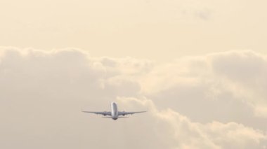 Airplane silhouette in cloudy sky climb. Jet plane flies away, long shot rear view. Tourism and travel concept