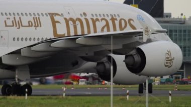 DUSSELDORF, GERMANY - JULY 23, 2017: Huge commercial airplane Airbus A380 of Emirates taxiing at Dusseldorf airport. Four-engine double-deck wide-body aircraft arrival