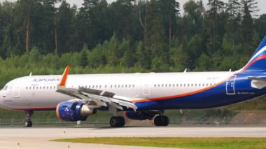 MOSCOW, RUSSIAN FEDERATION - JULY 29, 2021: Passenger airplane Airbus A321 of Aeroflot landing and braking at Sheremetyevo airport SVO. Airplane braking, side view